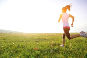 Runner athlete running on grass seaside.